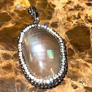 Beautiful shell pendant encrusted with layers of hand set hematite and clear